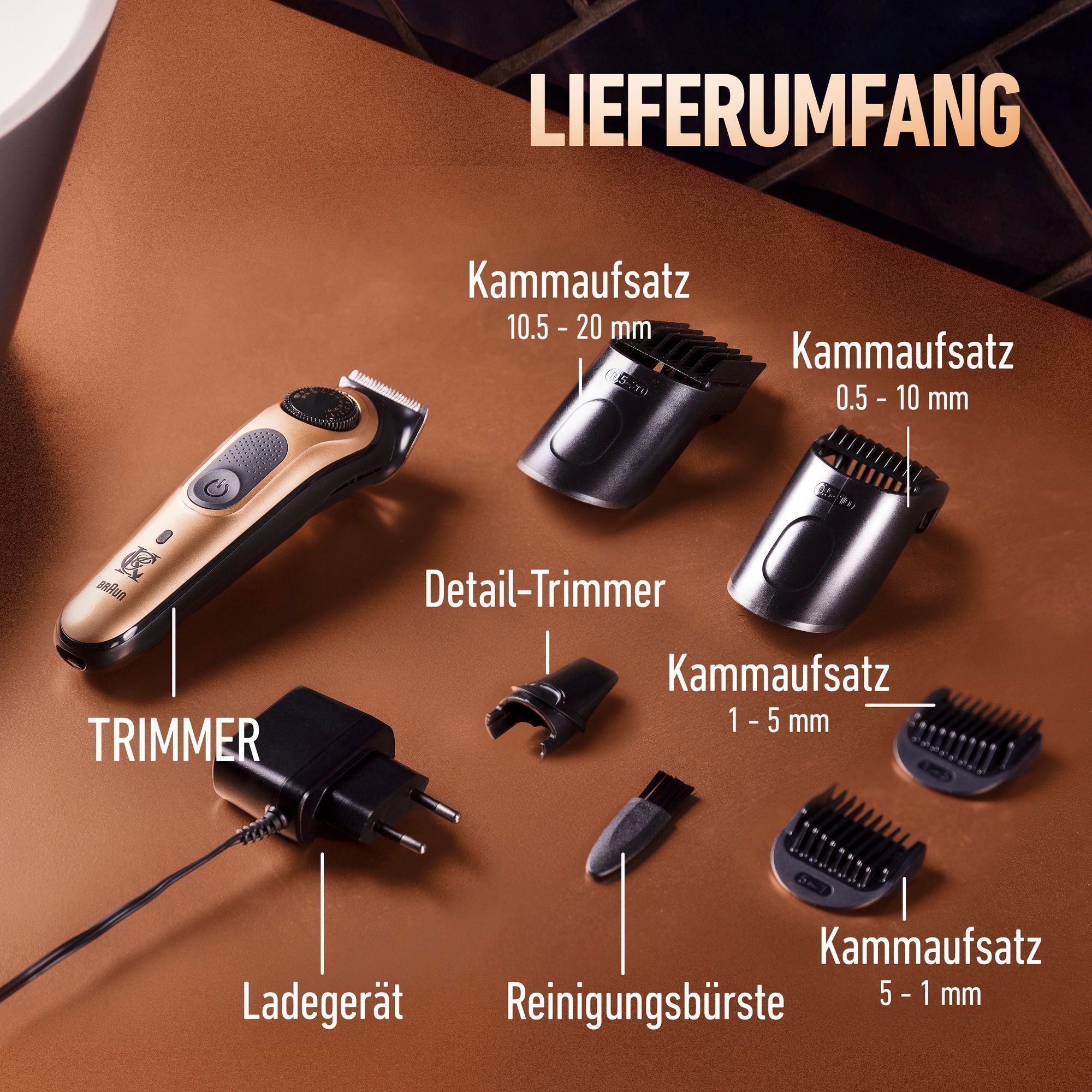 Die Trimmer Pro Box mit LadegerÃ¤t, ReinigungsbÃ¼rste, Detail-Trimmer und 4 KÃ¤mmen sind auf einer kupferfarbenen BadoberflÃ¤che angeordnet